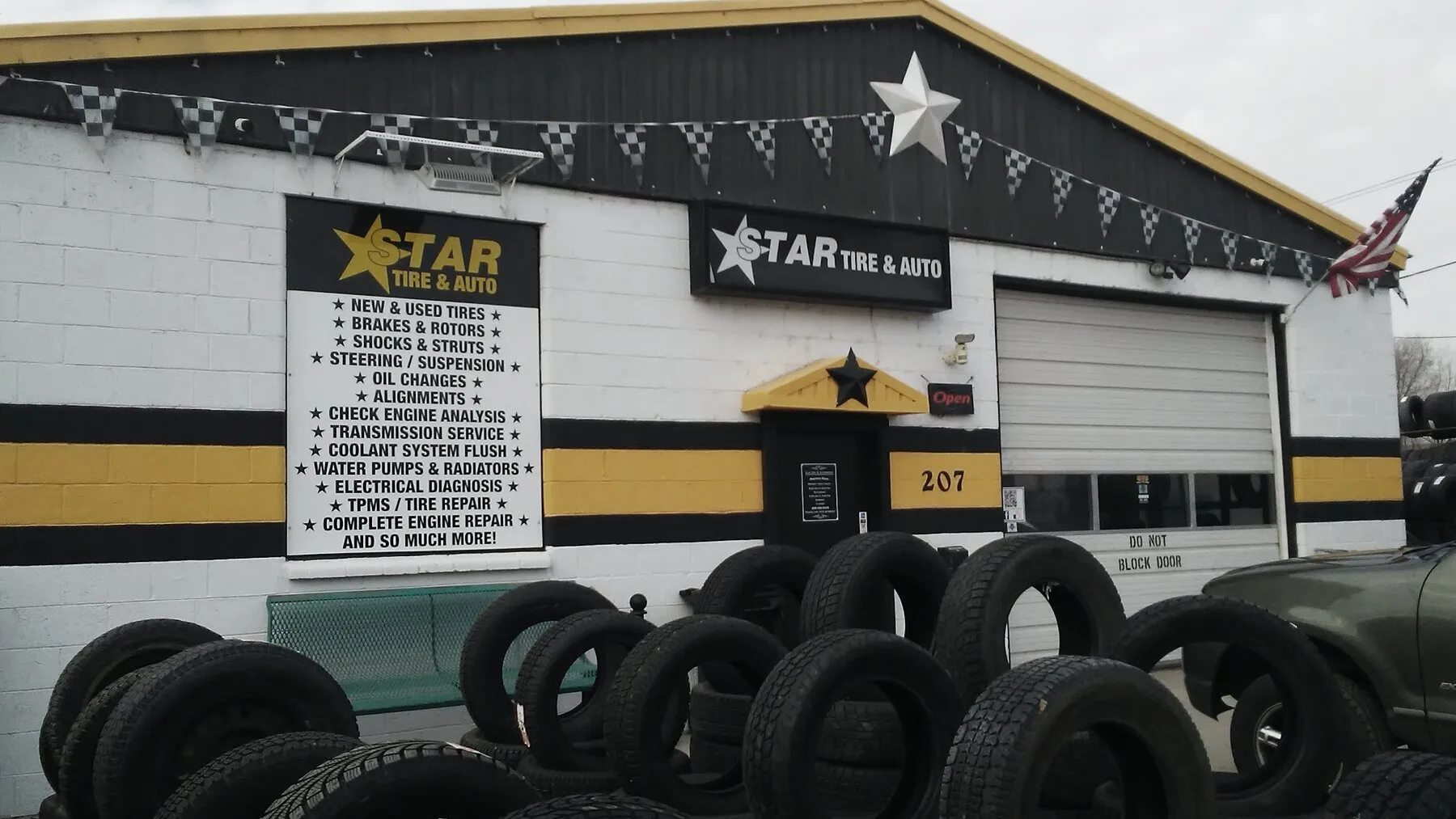The Star Tire storefront and hand-painted service board, tire stacks in the lot